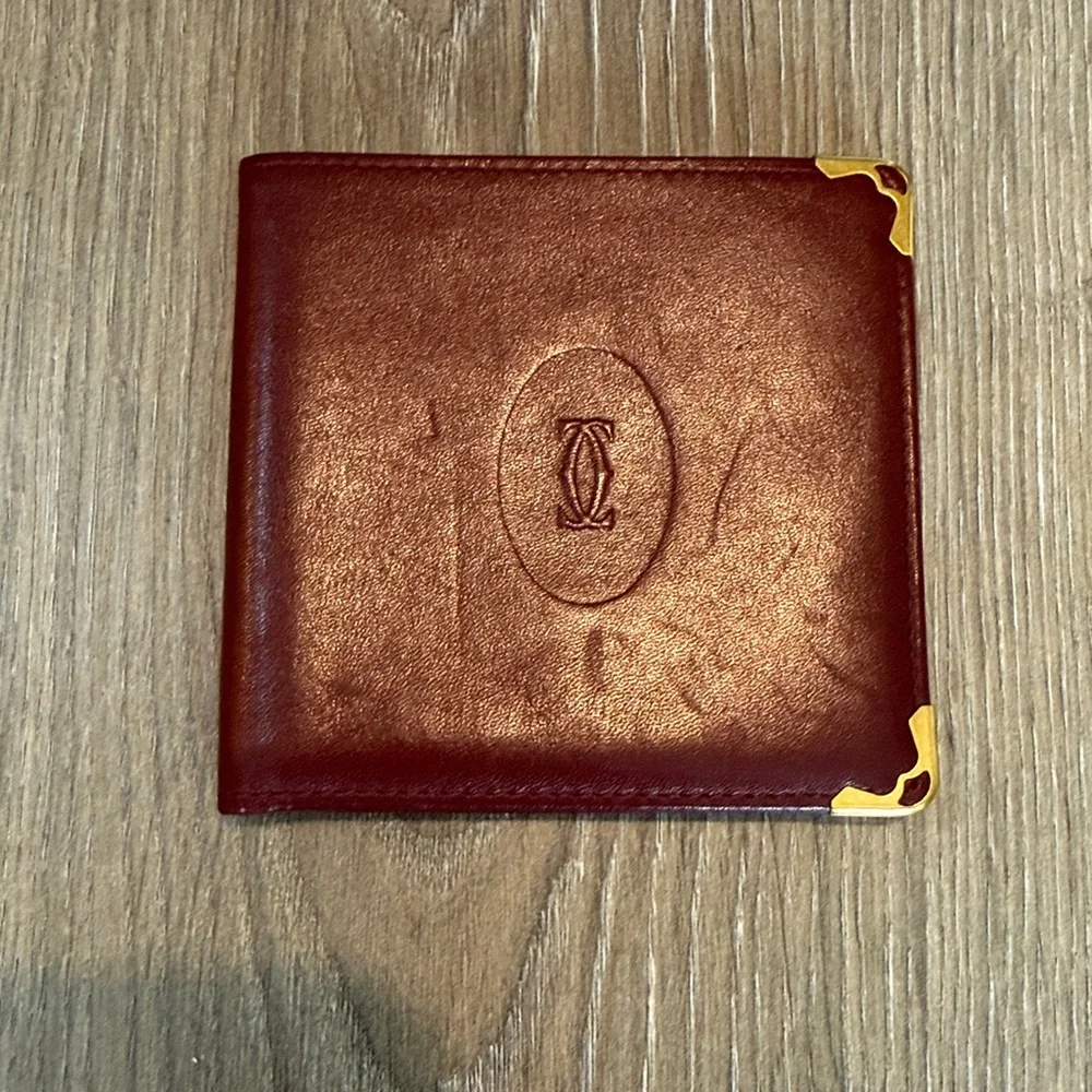 Cartier Men’s Deep Red Leather Bifold with Gold Corners